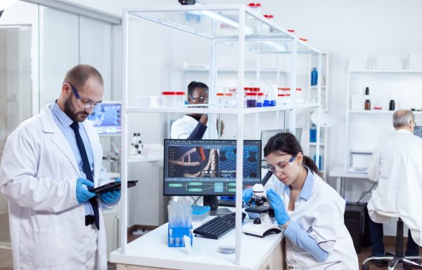 Chemist scientists doing vacine study in busy lab